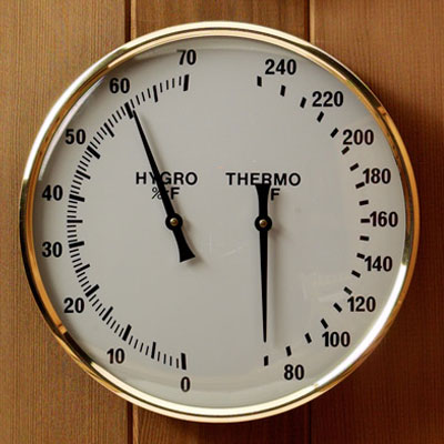Gold rimmed glass encased dual thermometer/hygrometer (7" diam., °F)